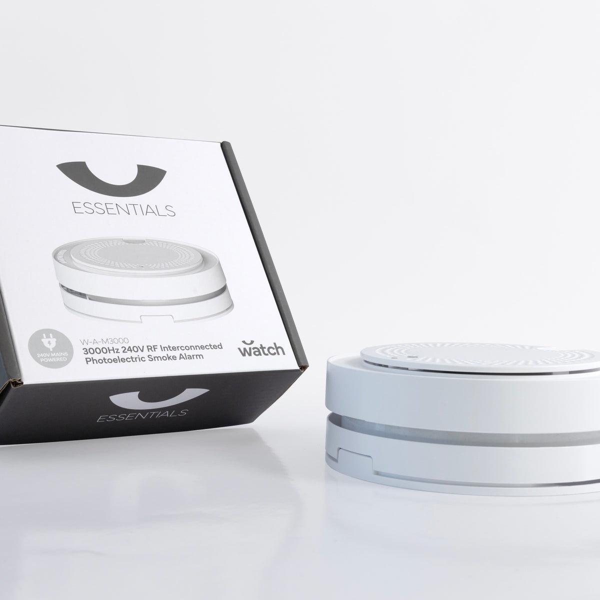 White smoke alarm with packaging on a white background