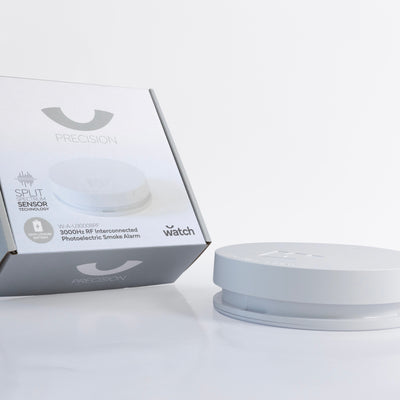 White smoke alarm with packaging on a white background