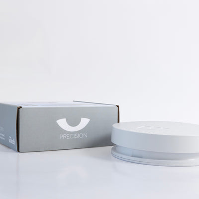White smoke alarm and box with 'Precision' branding on a light gray background
